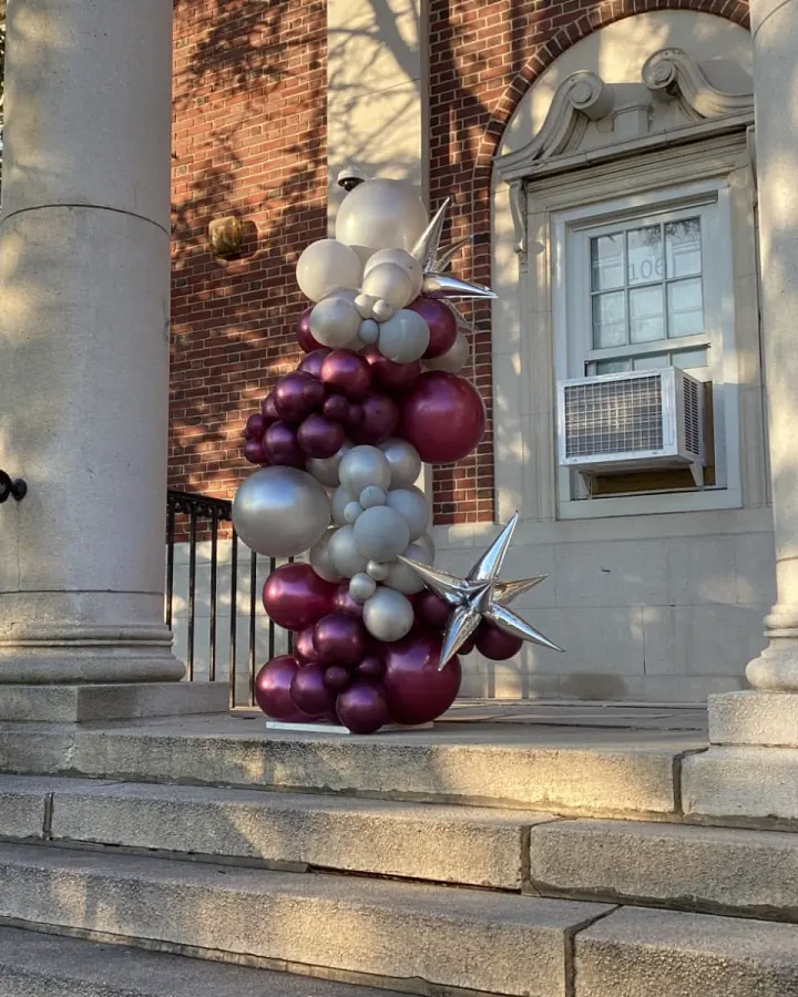 Organic maroon, silver and pearl balloon column with silver starbursts on a school entrance, New Jersey