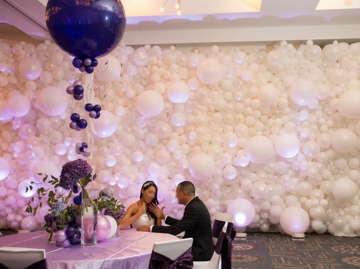 White organic balloon wall behind a bride and groom at a New Jersey wedding reception