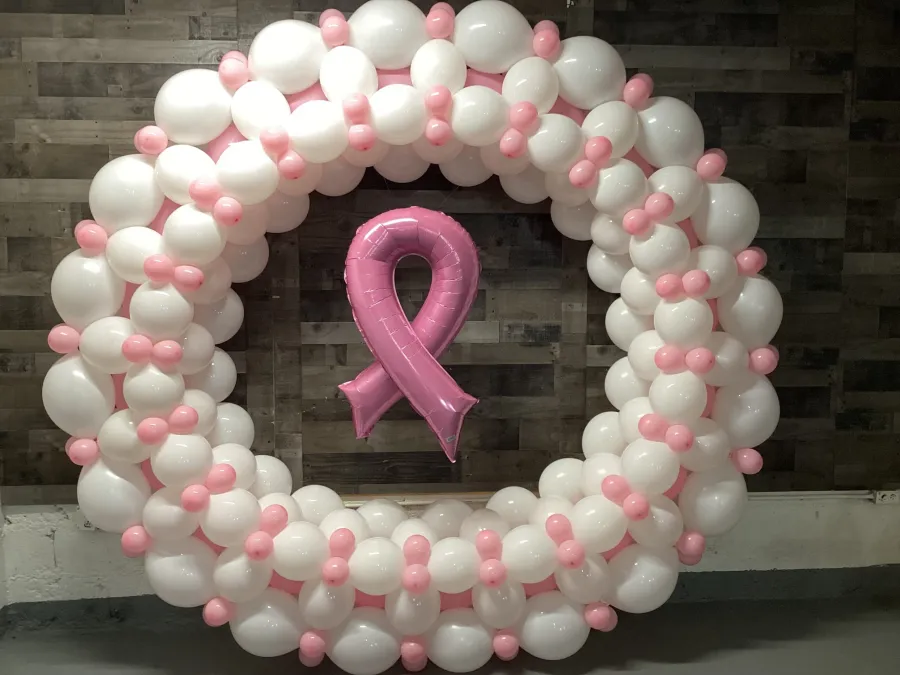 Pink and white balloon wreath with a pink awareness ribbon at its center for Breast Cancer Awareness Month, New Jersey