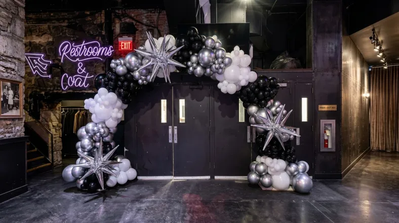 Black, silver and white organic balloon arch with silver starburst balloons framing venue doors, New Jersey