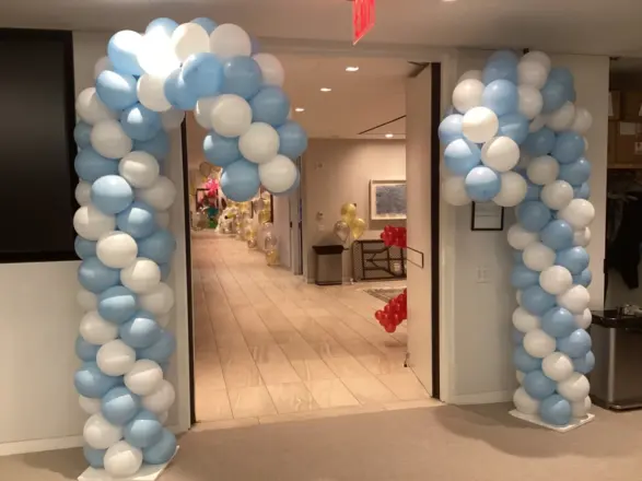 Blue and white candy cane balloon columns at an entrance, New Jersey