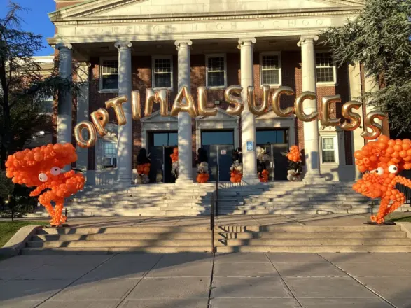 Orange balloon sculptures at a school entrance, New Jersey